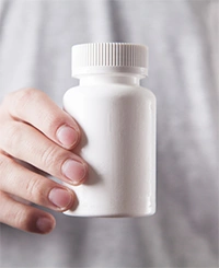 A blank, unlabeled supplement bottle